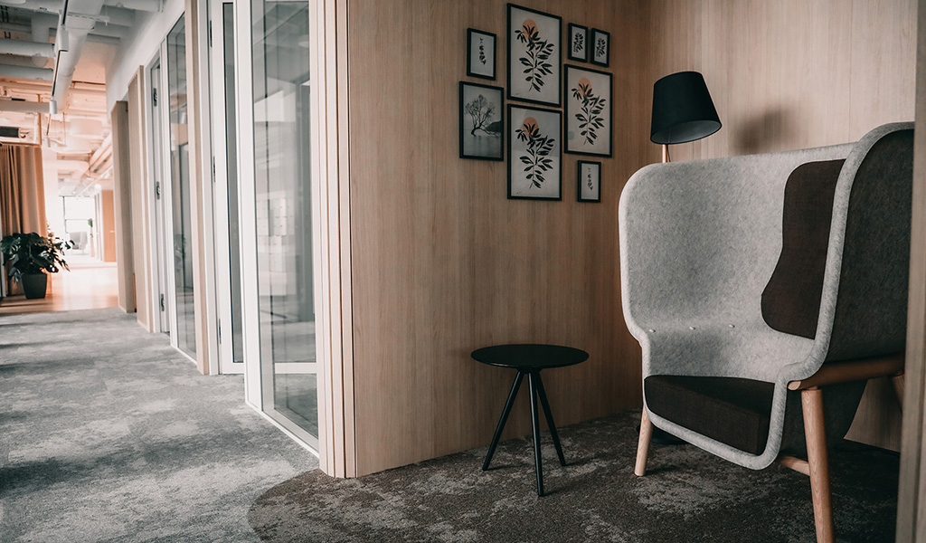 Silent space with armchair and side table and the office corridor