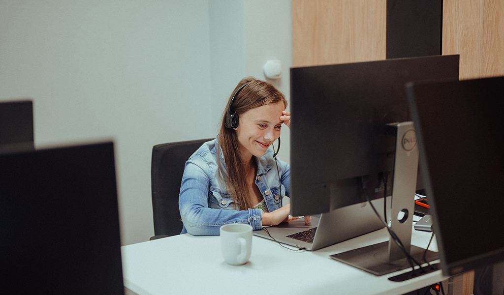 Data Analyst smiling during her call with colleagues