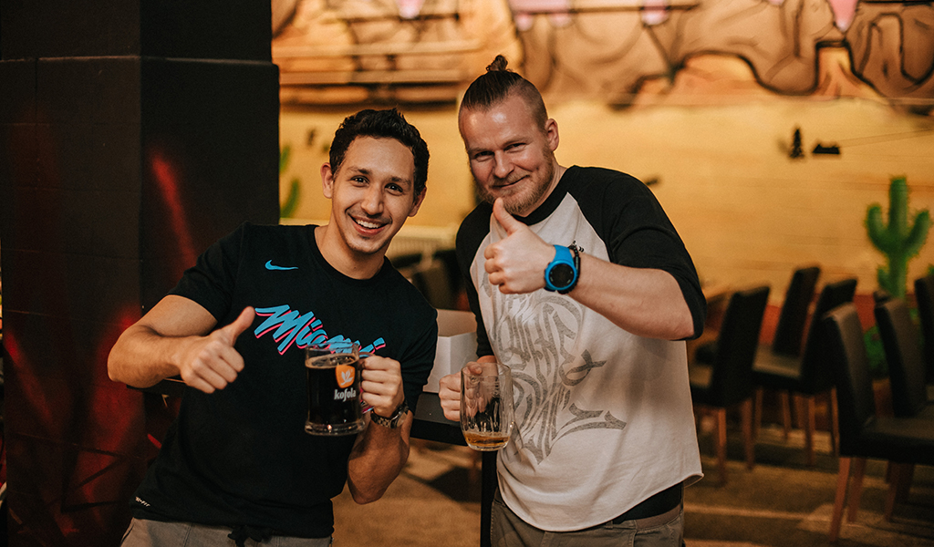 Two team members posing with their drinks