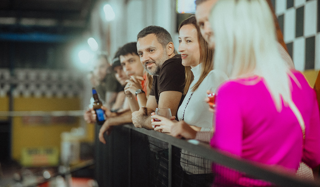 Team members watching go karts