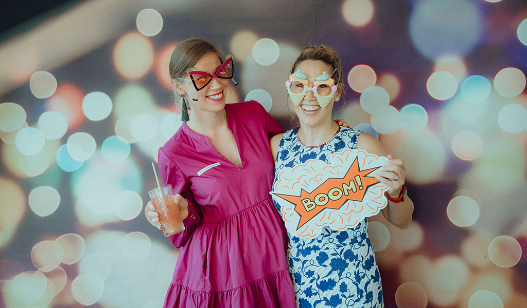 Two team members posing for a photo booth