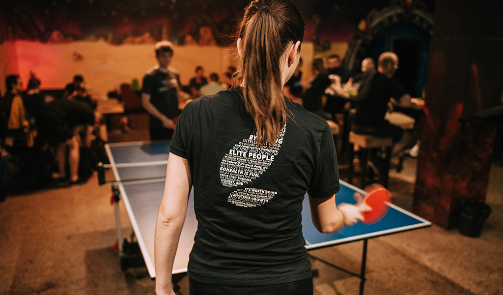 Team members playing table tennis