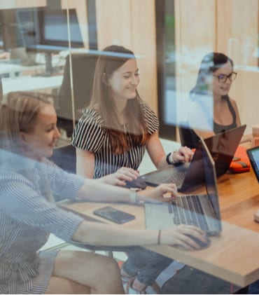 Three members of the recruiting team during a meeting in a focus room