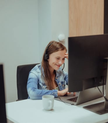 Data Analyst smiling during her call with colleagues