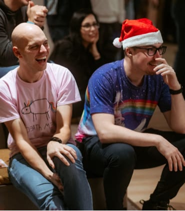 Team members of GoHealth laughing during the Christmas party