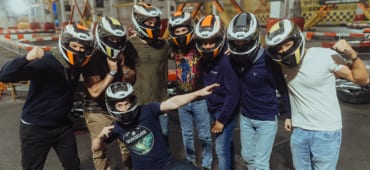 Team members of GoHealth posing in helmets