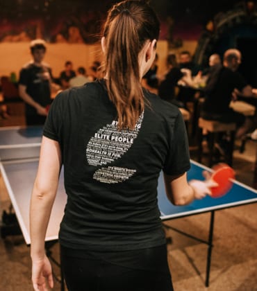 Team members playing table tennis