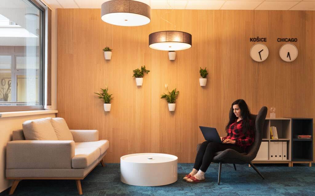 Woman working on her laptop in the office lounge.