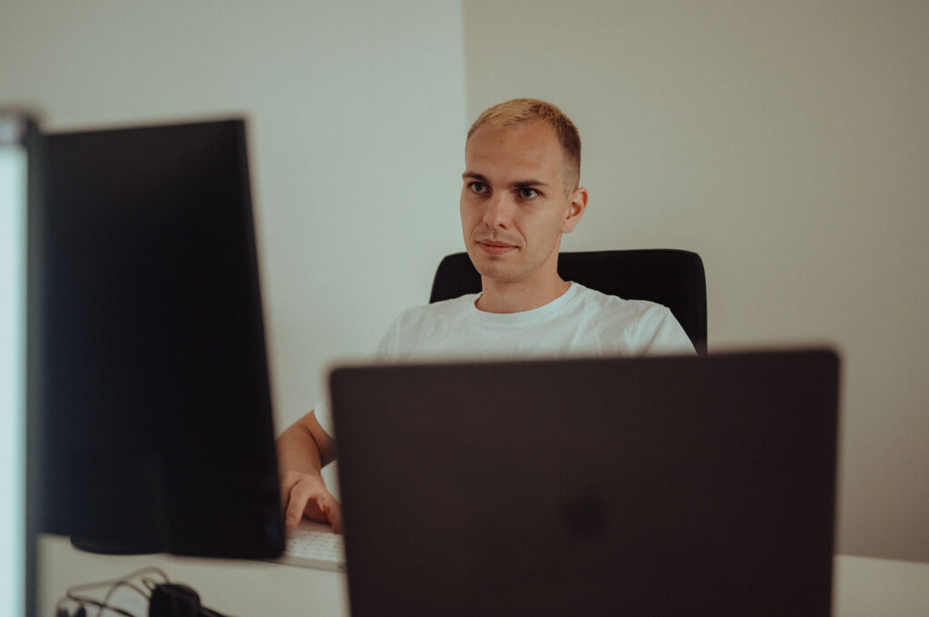 Data Engineer working on his computer in the office.