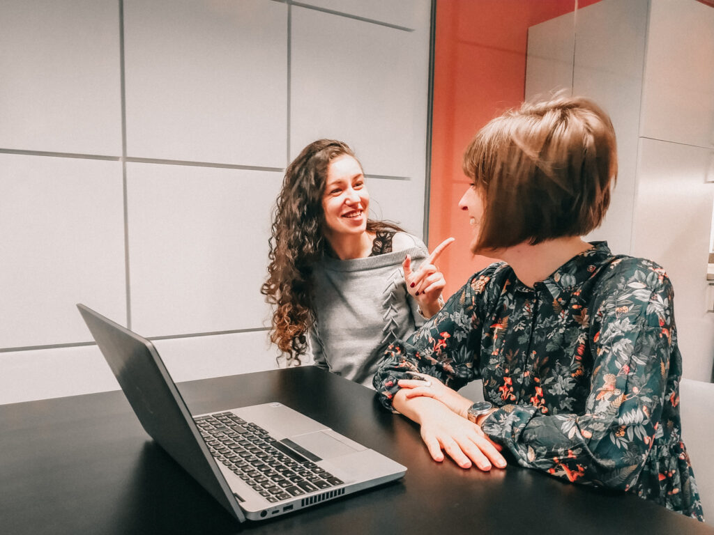 Two female QA Testers smiling.