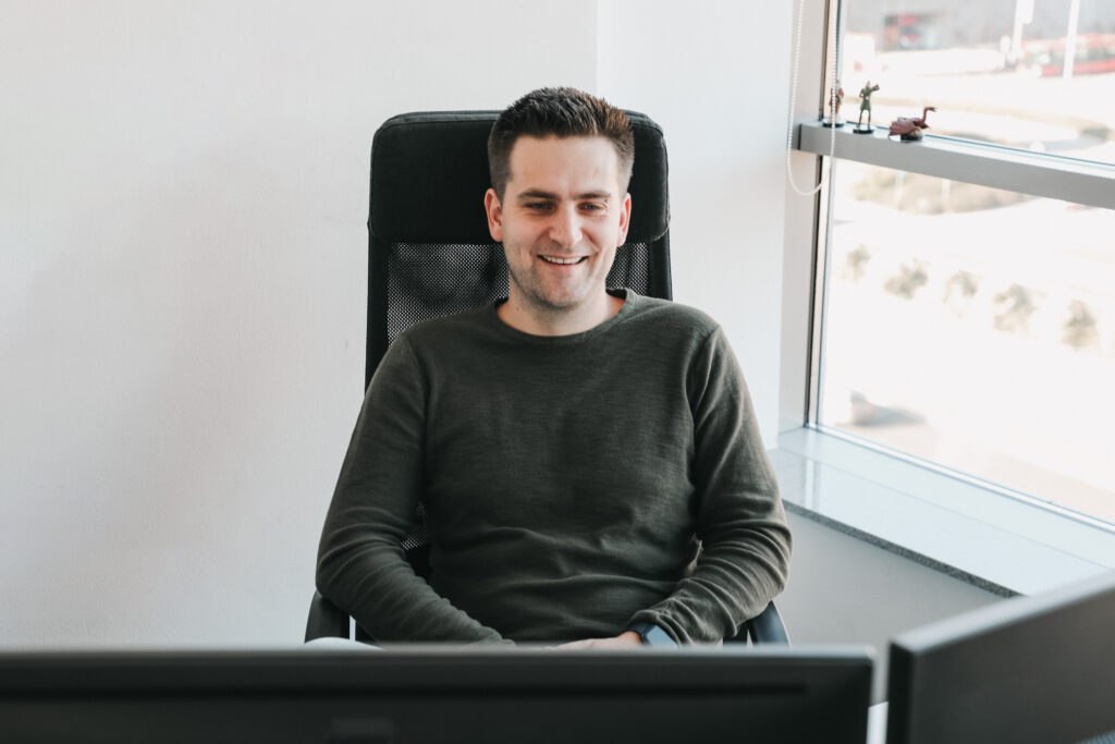Developer smiling at his screen.