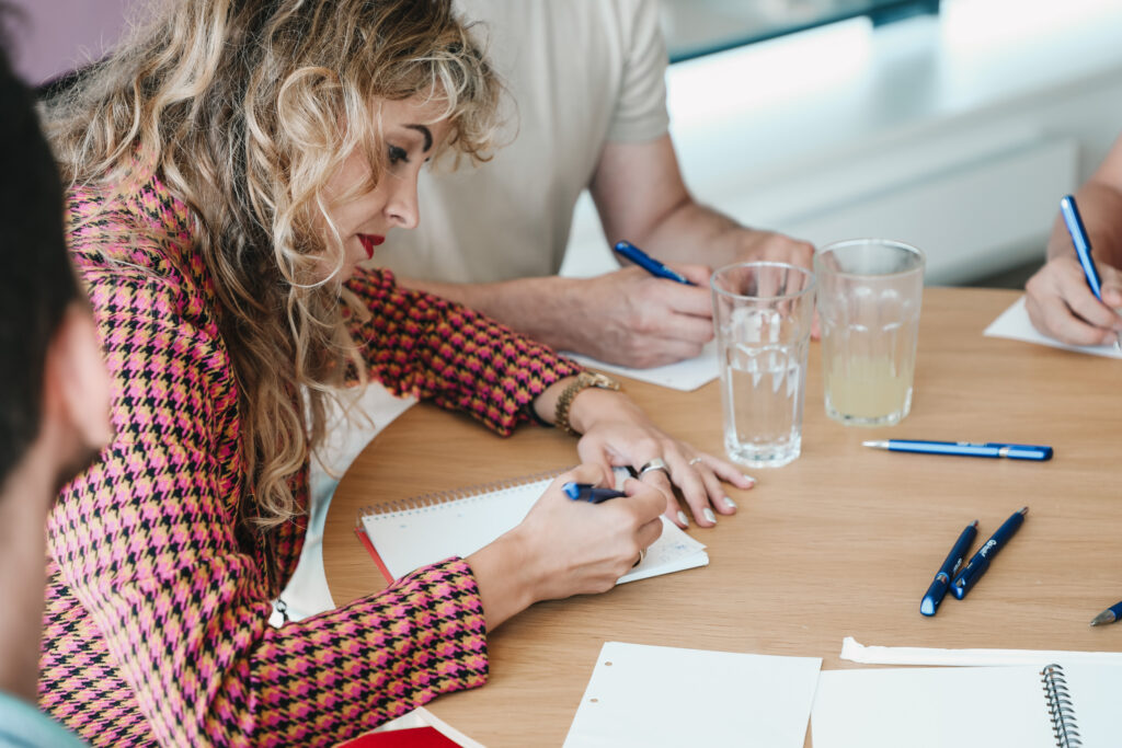 female project manager writing on a paper