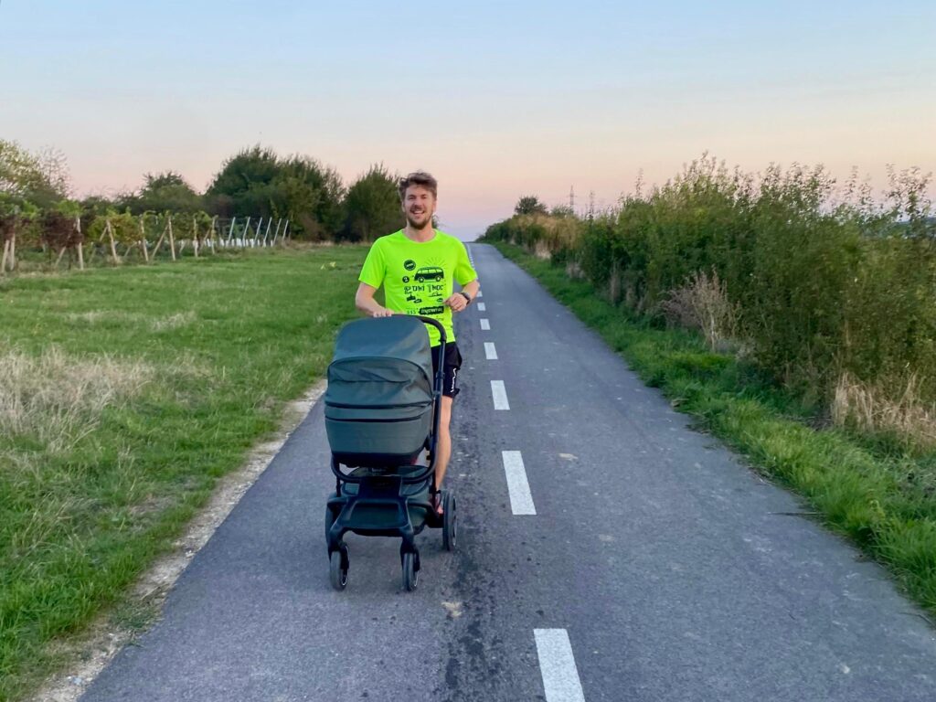 a man running with a baby in the stroller