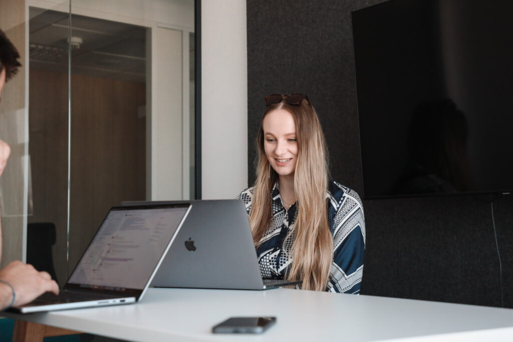 a female qa analyst on her laptop during a meeting